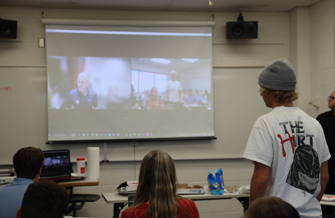 Michael Blood joining the BYU-Idaho entrepreneurship society by video call, projected on the classroom screen